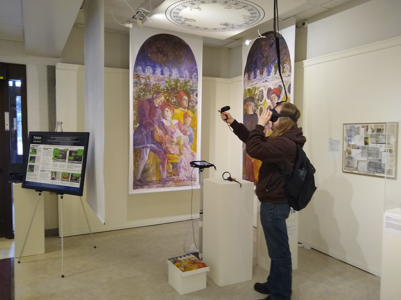 Photo showing a student trying out the virtual reality exhibit The Wedding Chamber